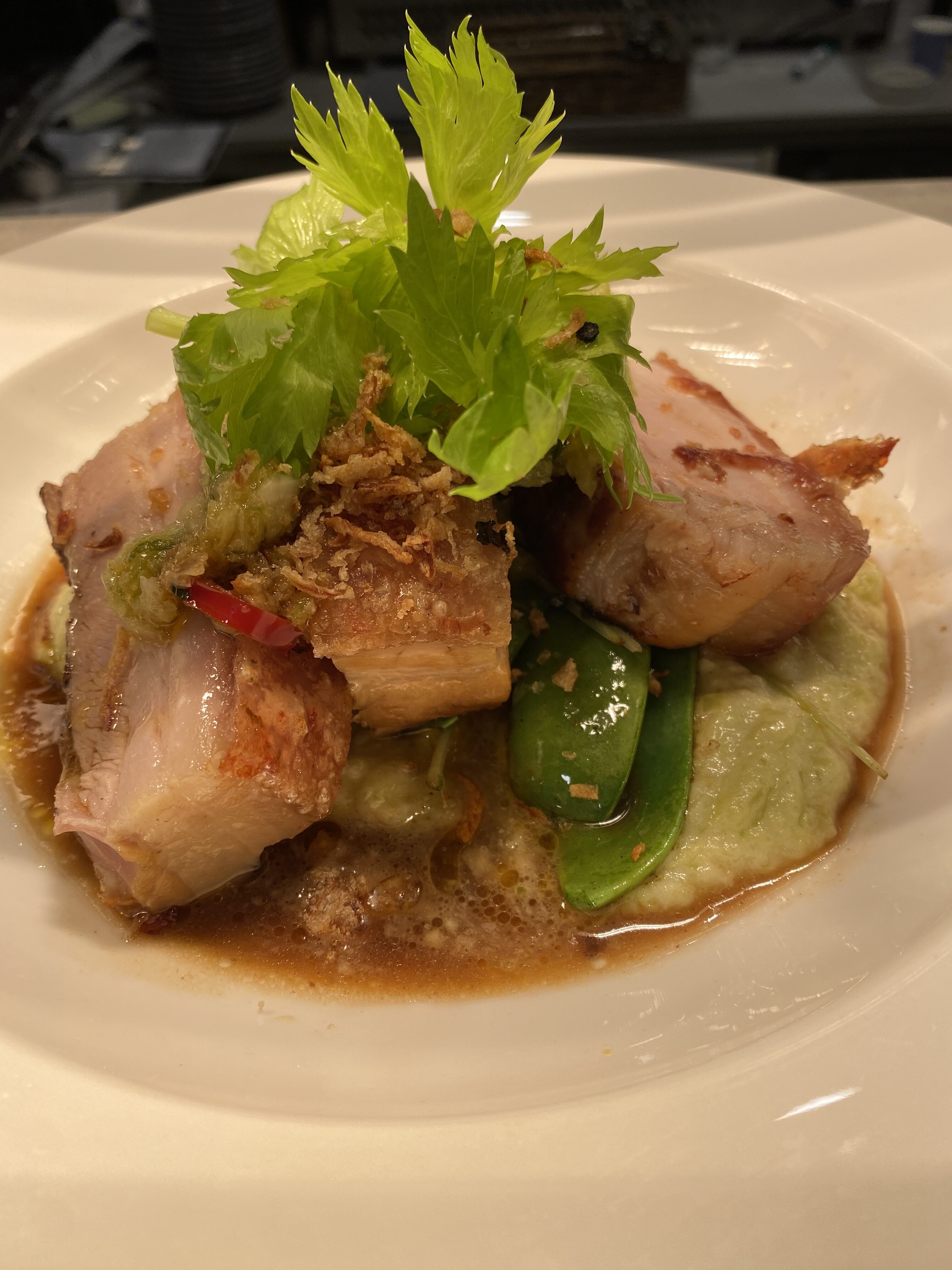 Pan-fried pork served with vegetables and sauce, showing how extra virgin olive oil can be safely used for high-heat stir-fry dishes while retaining flavor and health benefits